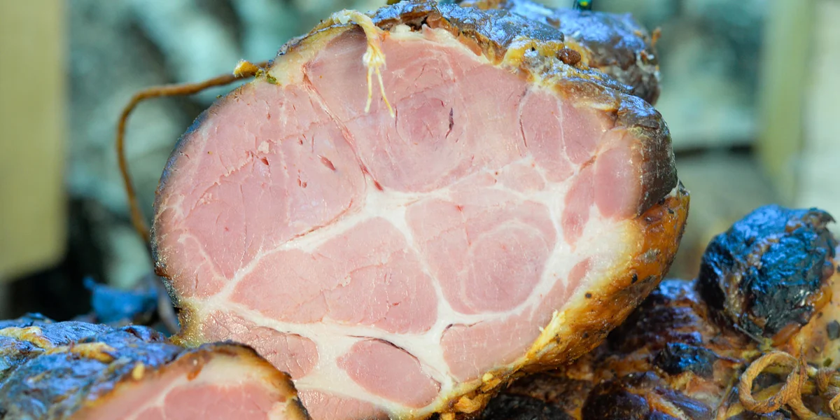 Sliced smoked pork neck showing its texture